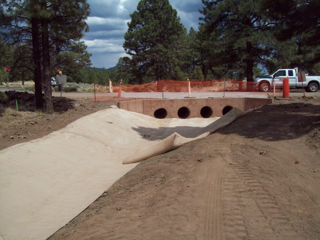 A drainage channel going under a road