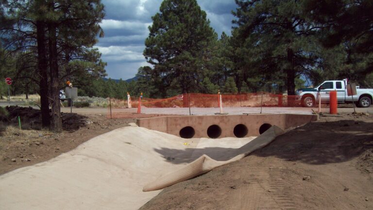 A drainage channel going under a road