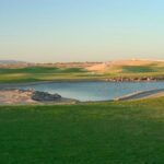 A golf course with a pond
