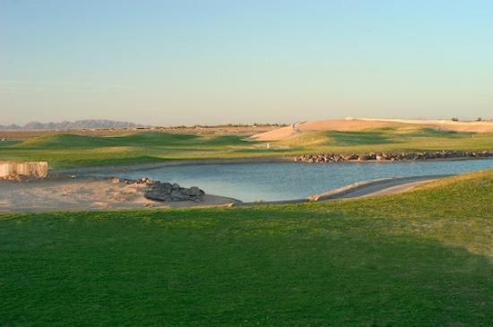 A golf course with a pond