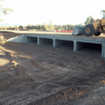 Completed drainage culvert with front loader on top