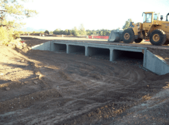 Completed drainage culvert with front loader on top
