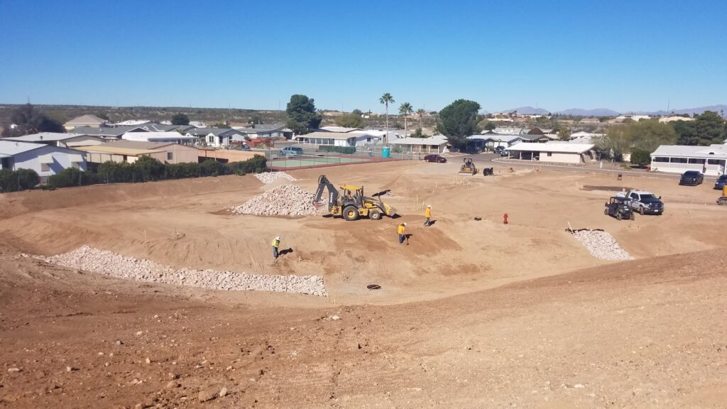 Construction crew with machines clearing a large area
