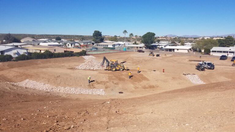 Construction crew with machines clearing a large area