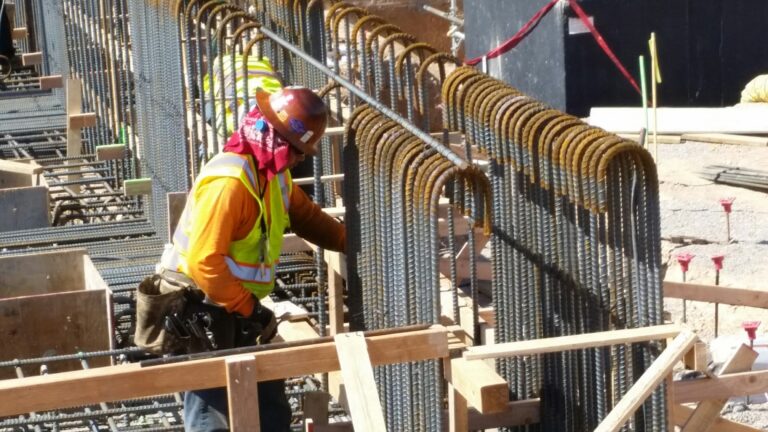 Construction worker installing rebar