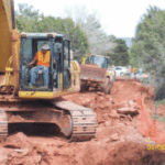 Construction worker operating a backhoe