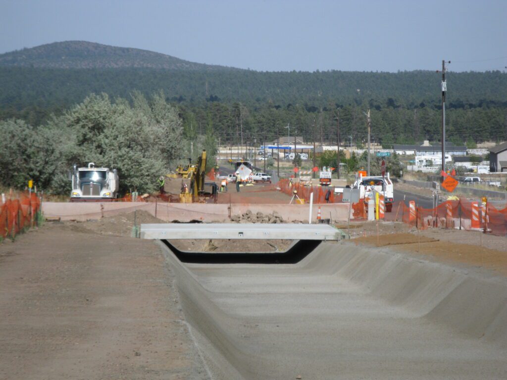 Construction zone next to a road - concrete drainage channel