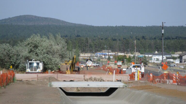 Construction zone next to a road - concrete drainage channel