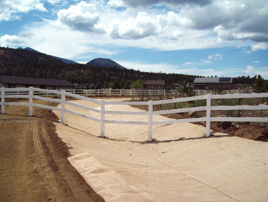 Drainage channel with a fence across it