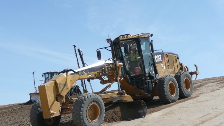 Earth mover grading a slope