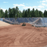 Earth movers digging out giant hole