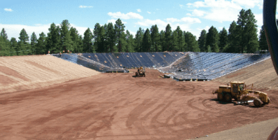 Earth movers digging out giant hole
