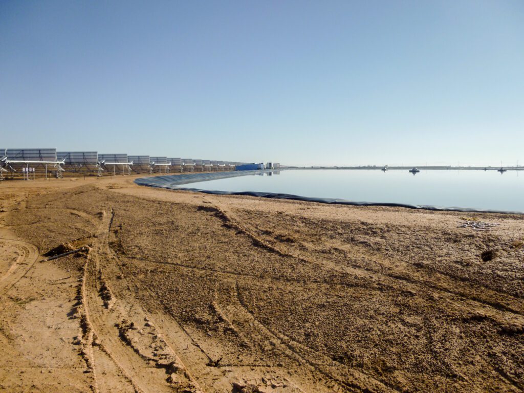 Evaporation pond with liner near some solar panels