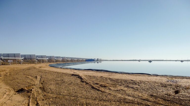 Evaporation pond with liner near some solar panels