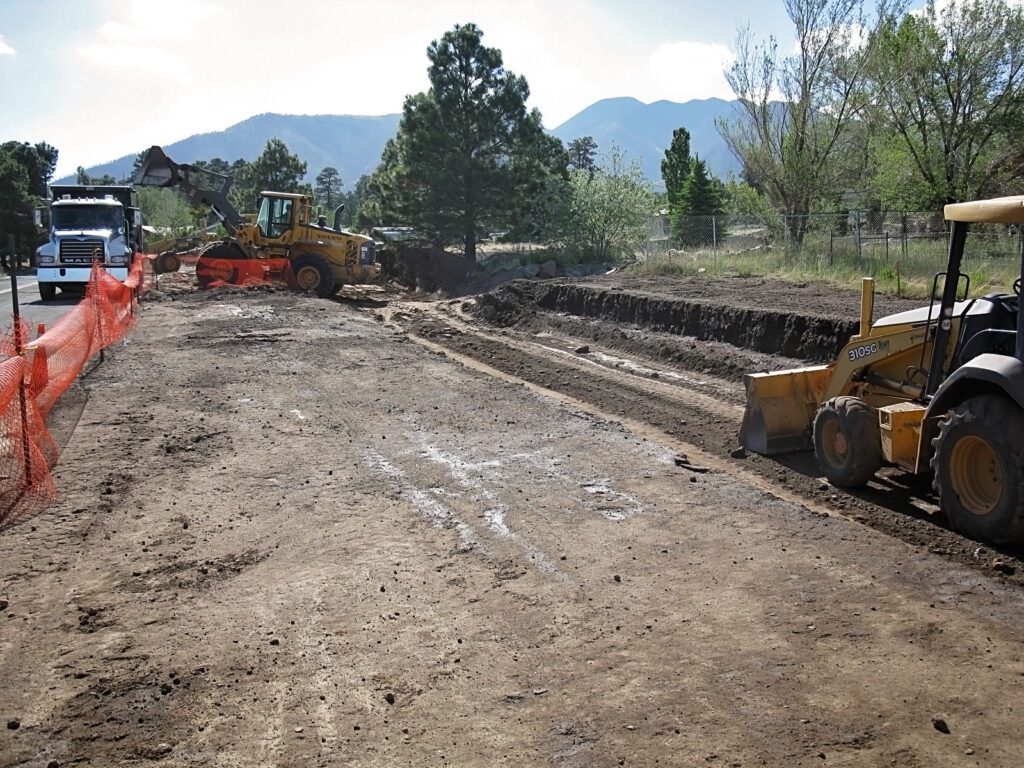 Front loader filling a truck with dirt