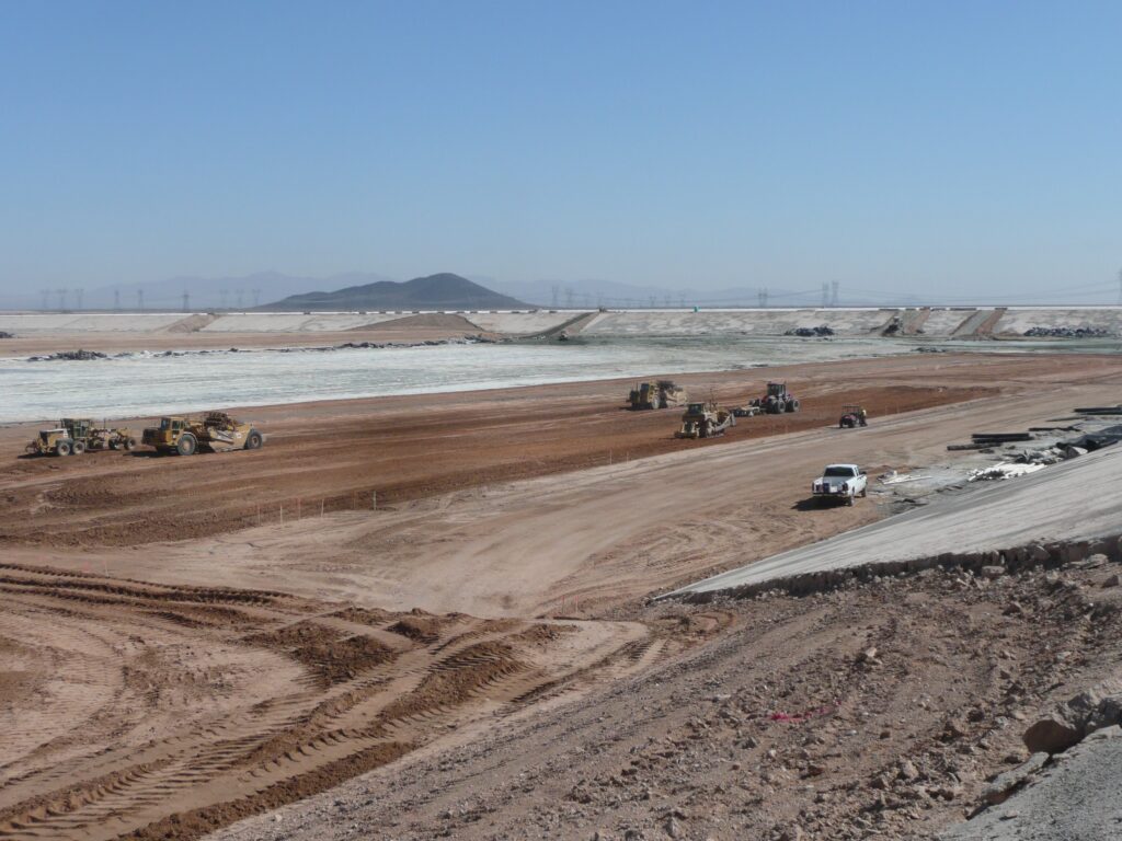 Many earth movers grading a vast area