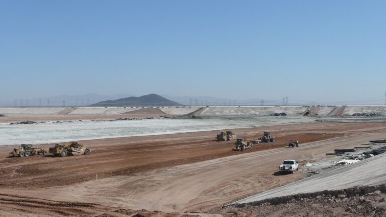 Many earth movers grading a vast area