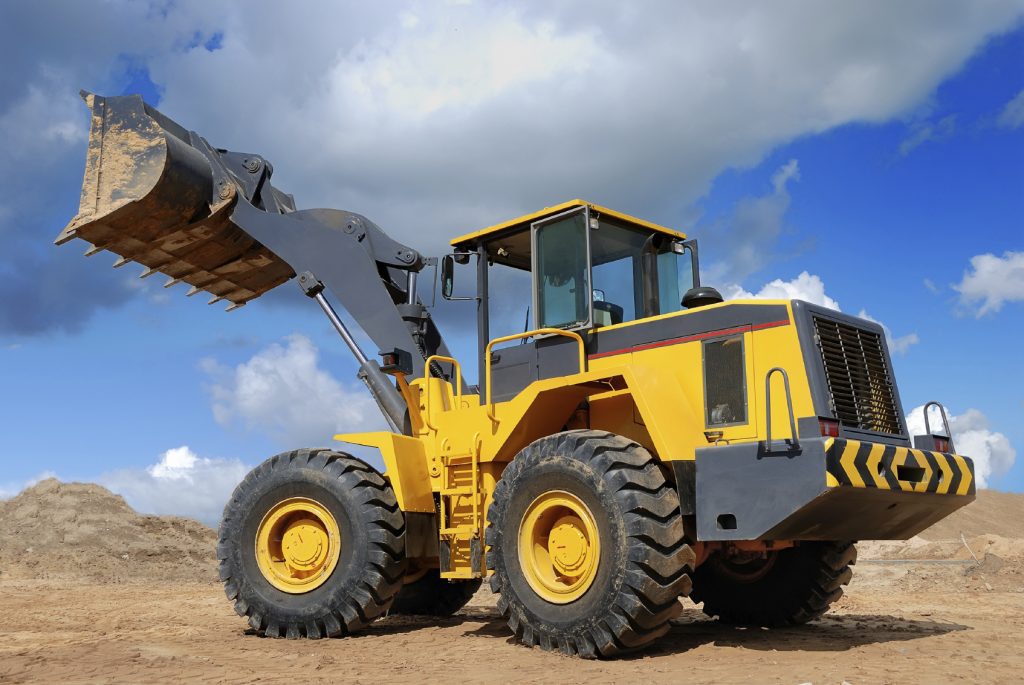 Diesel wheel loader with risen bucket outdoors